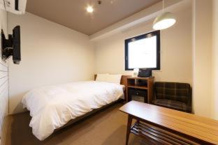 Postel nebo postele na pokoji v ubytování Hotel Citio Shizuoka