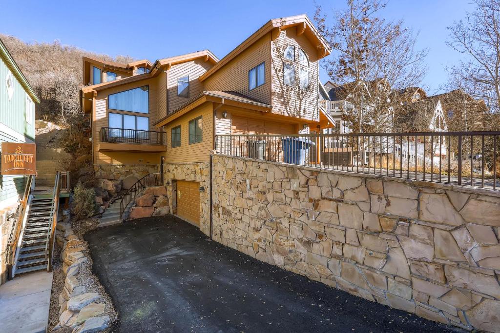 a house with a stone wall and a driveway at Deer Point #1 in Park City