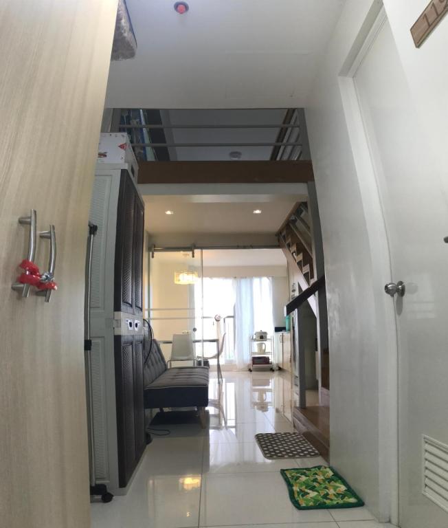 an empty hallway with a staircase in a house at Tagaytay Family vacation condo unit wind residences in Tagaytay
