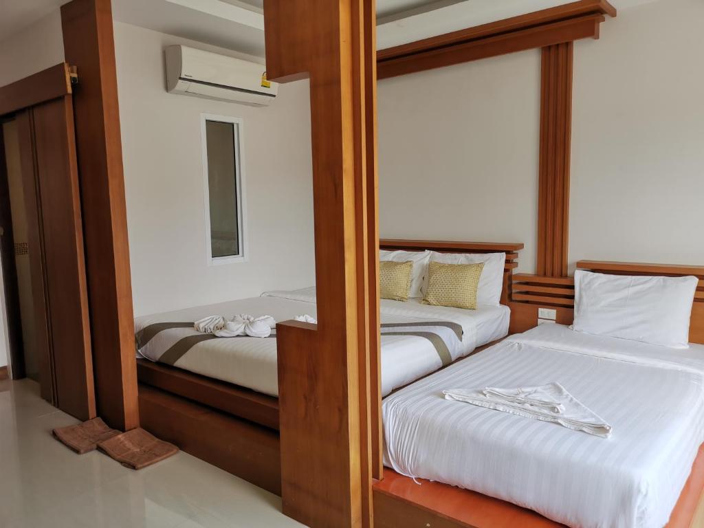 two bunk beds in a room with a mirror at The Peace Tara House in Ko Lanta