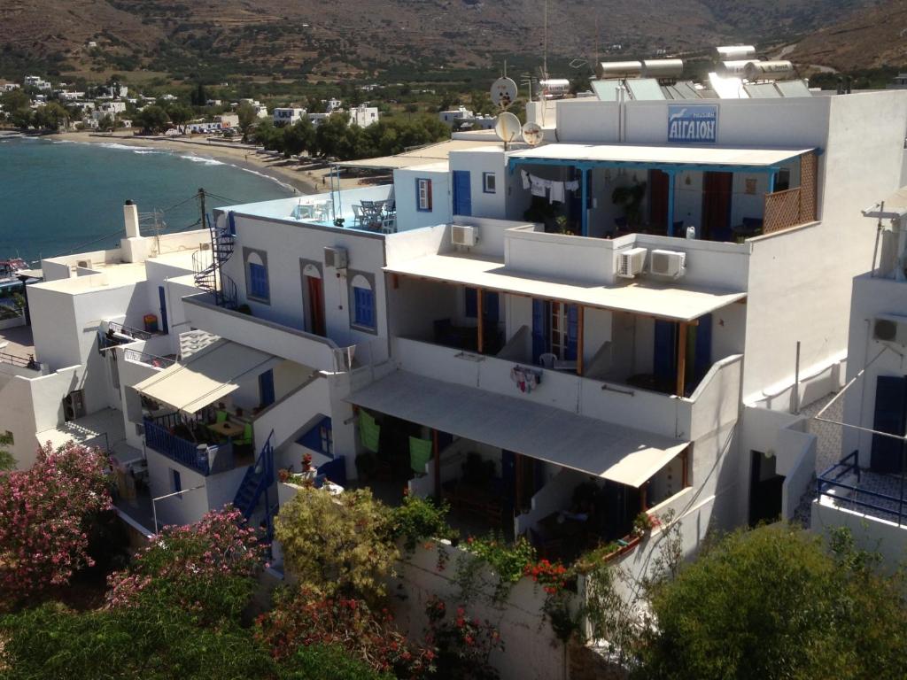 an aerial view of a white building with a beach at Aegeon Pension in Aegiali