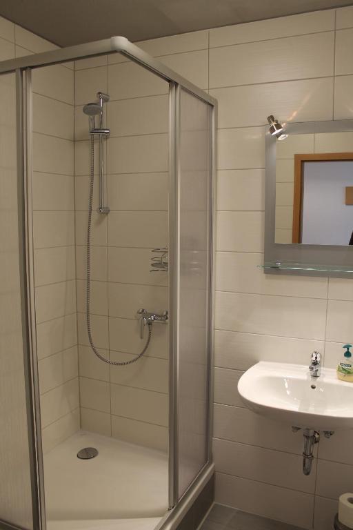 a bathroom with a shower and a sink at Pension Take Off in Gera
