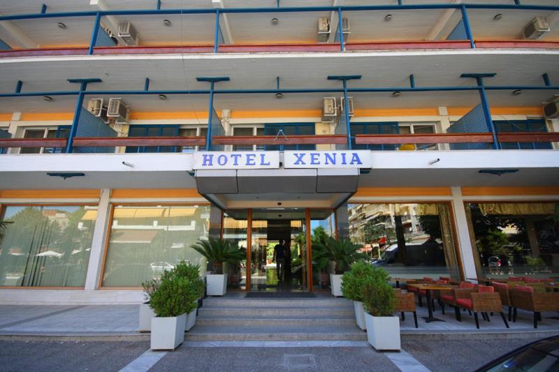 a hotel kenia with tables and chairs in front of a building at Xenia Hotel Drama in Drama