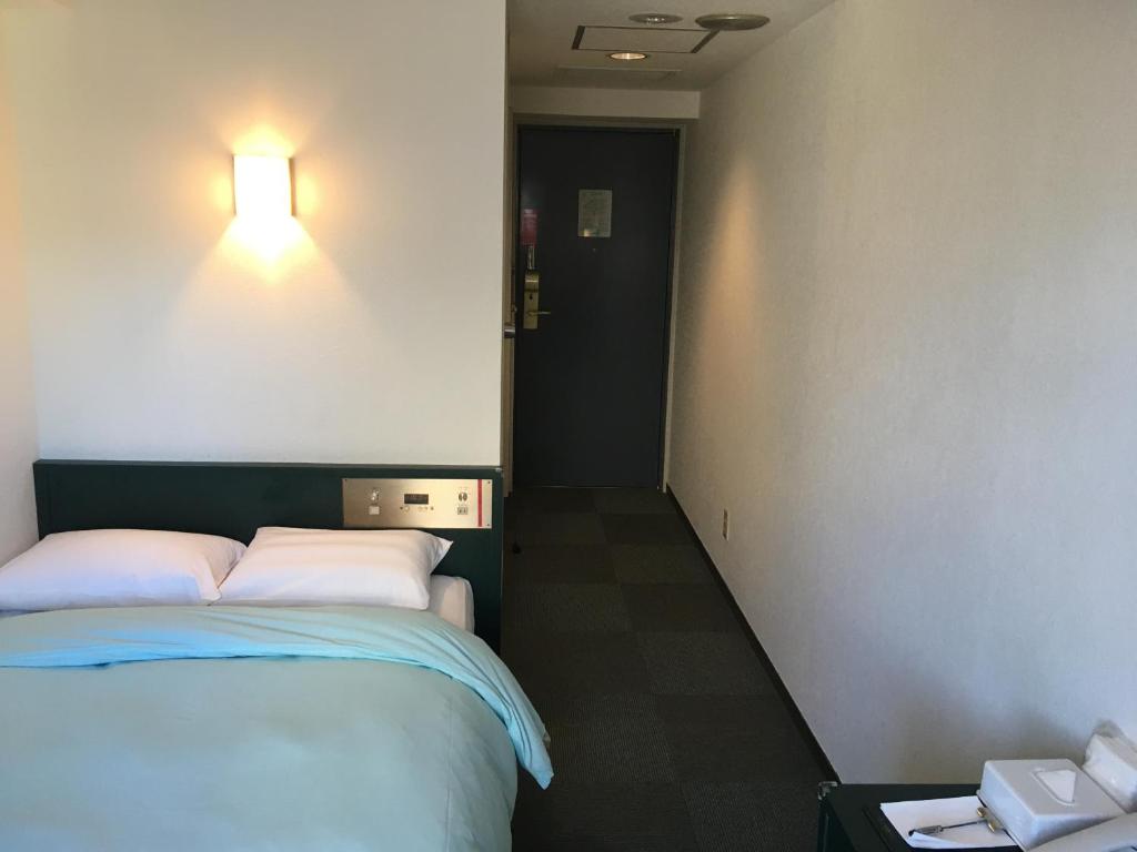 Postel nebo postele na pokoji v ubytování Olympic Inn Azabu