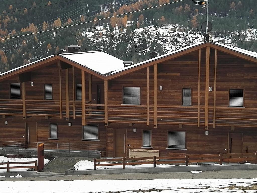 a wooden building with two benches in front of it at Villa Belvedere in Valdidentro