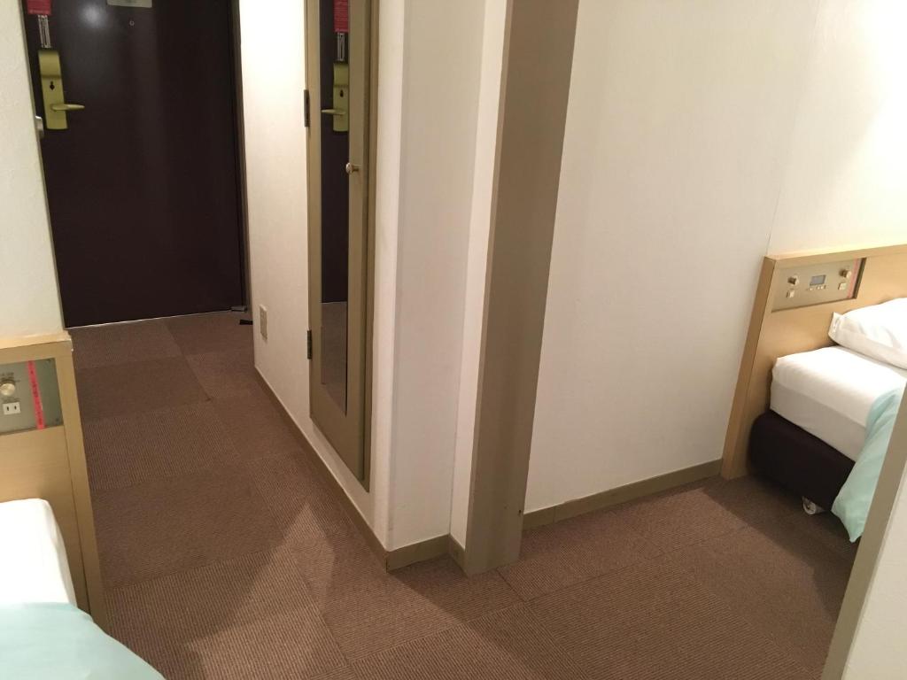 Postel nebo postele na pokoji v ubytování Olympic Inn Azabu