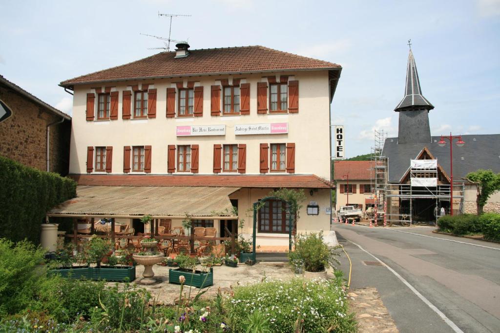 a building on the side of a street with a church at Auberge Saint Martin in Saint-Martin-Terressus