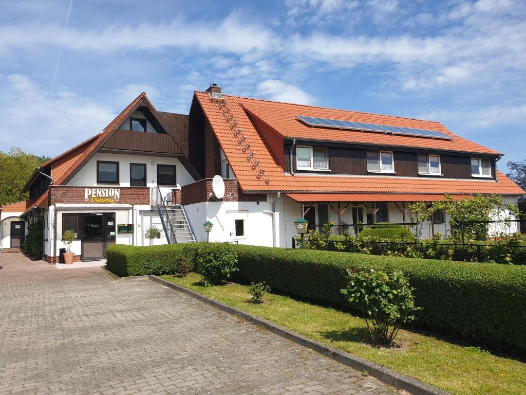 a house with an orange roof on a street at Pension Dalina in Sagard