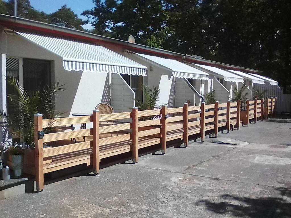 a row of wooden fences in front of a building at Pension Fürst Borwin in Markgrafenheide