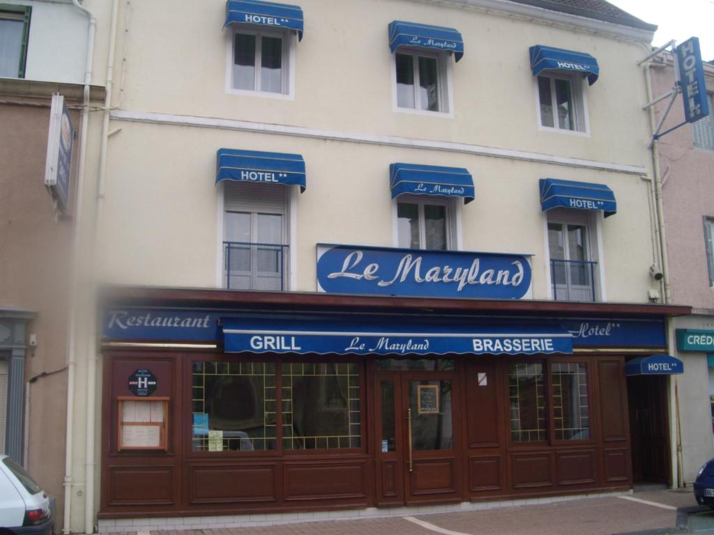 a building with blue signs on the front of it at Le Maryland in Blanzy