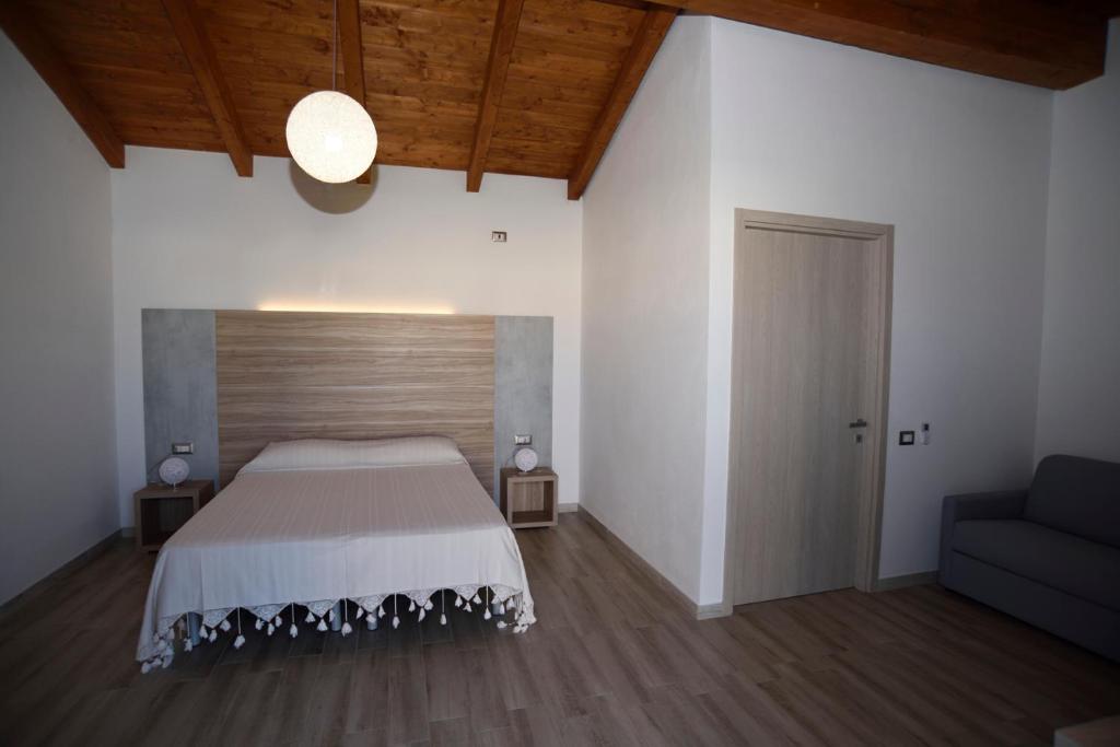 Кровать или кровати в номере Agriturismo al Riparo dai Venti
