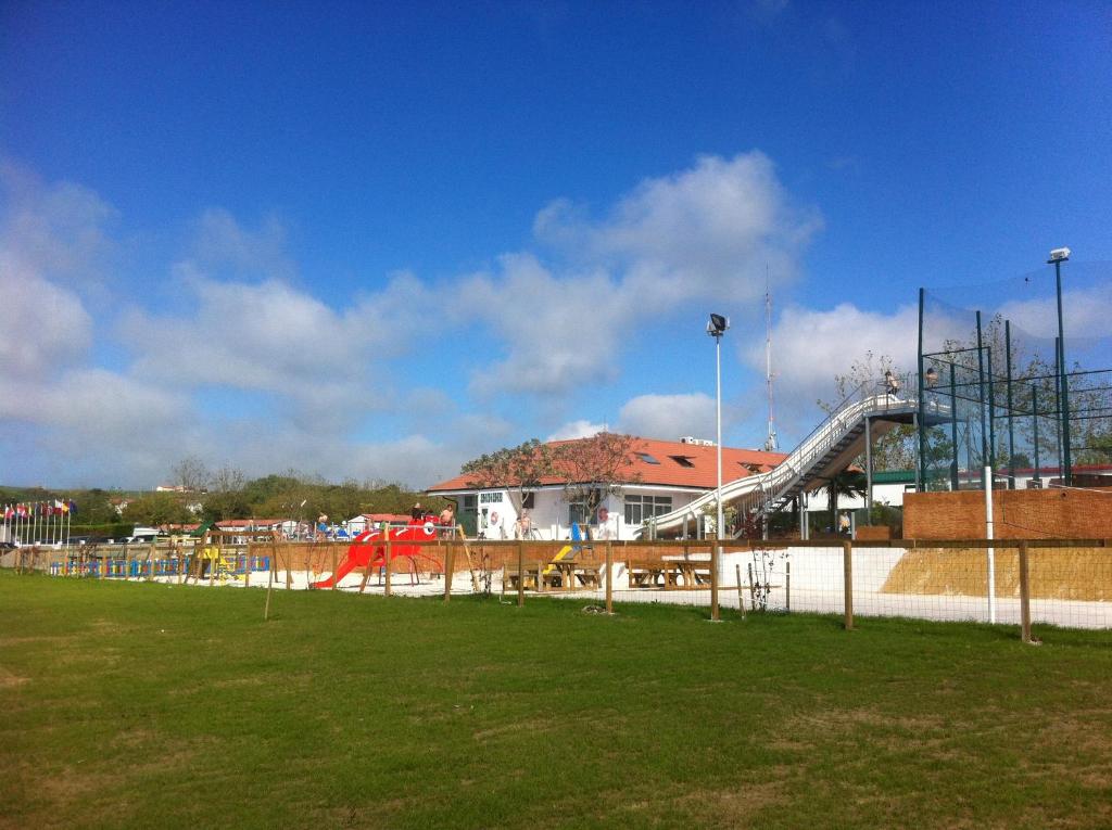 a park with a playground with a slide at Pension Arenas in Ajo