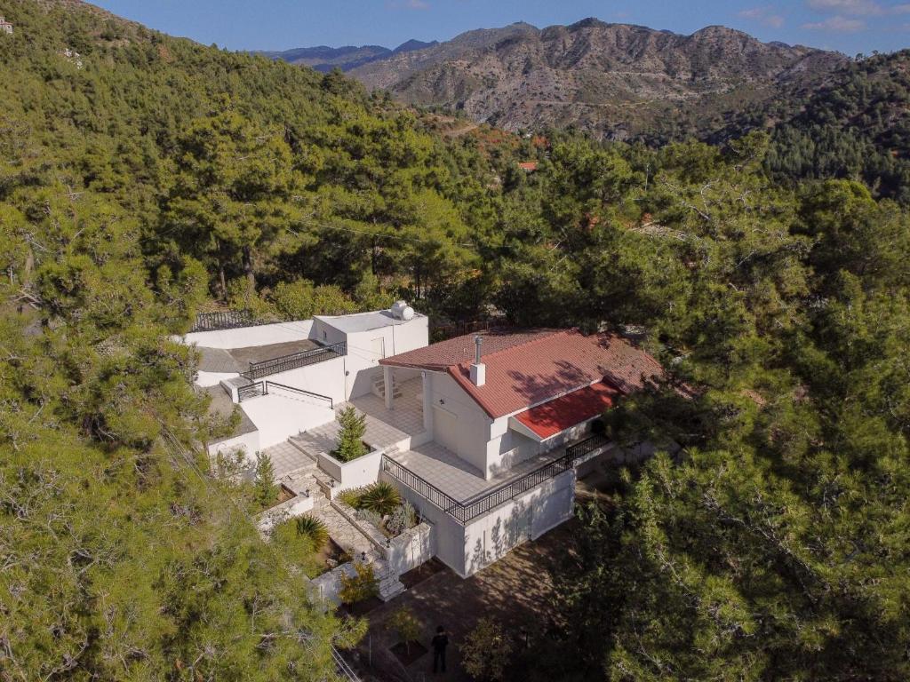 an aerial view of a white house in the mountains at Nestor Hillside House by TrulyCyprus in Moniatis