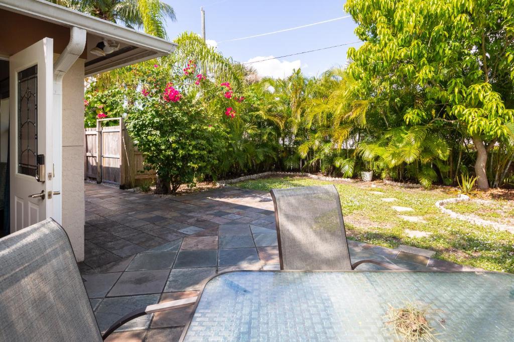 a table and a chair on a patio at Home by Beach 3 - Delnor-Wiggins in Naples