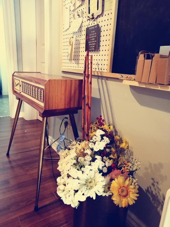 a desk with a bouquet of flowers next to a table at Lily's garden in Charlottetown