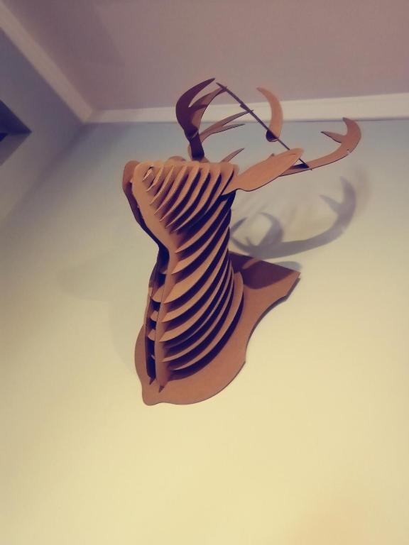 a wooden sculpture of a fish on a floor at Lily's garden in Charlottetown