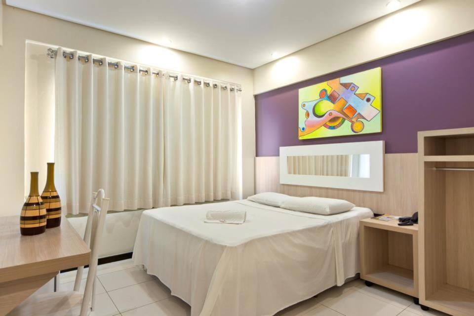 Postel nebo postele na pokoji v ubytování Eunapolis Plaza Hotel