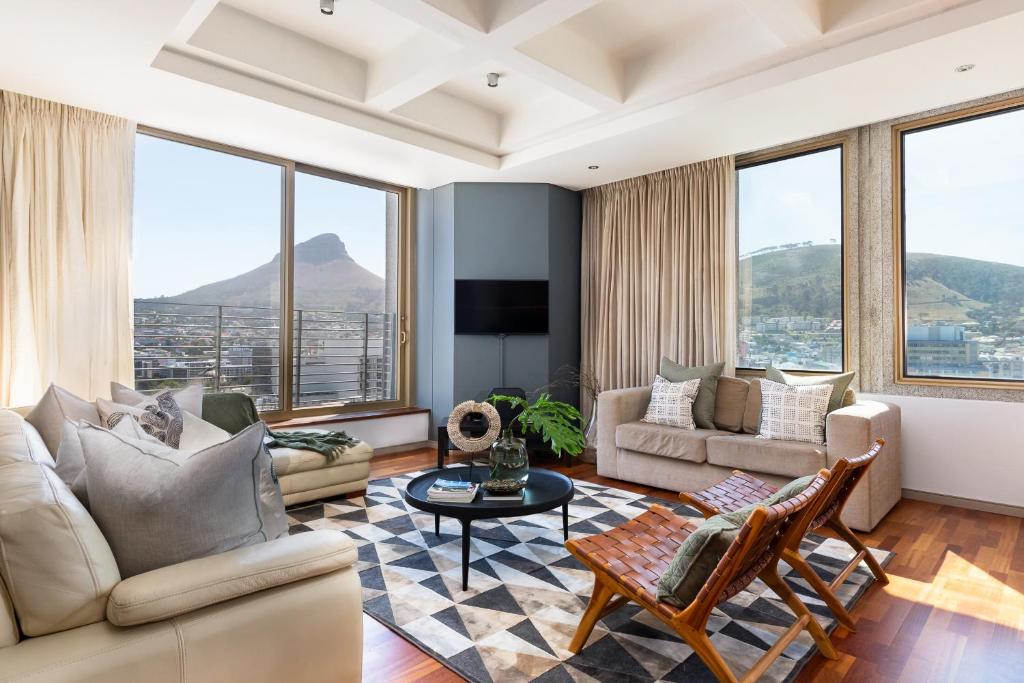 a living room with a couch and a table at #1804 Cartwright - Spacious and Elegant in Cape Town