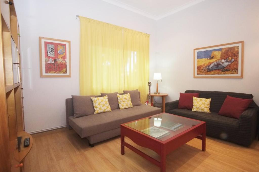 a living room with a couch and a coffee table at Lovely Apartment at Park Güell in Barcelona