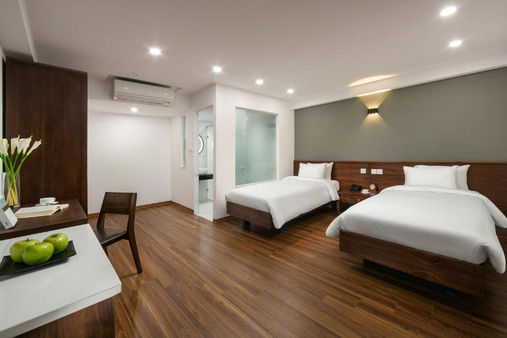 Postel nebo postele na pokoji v ubytování Hanoi Exclusive Hotel