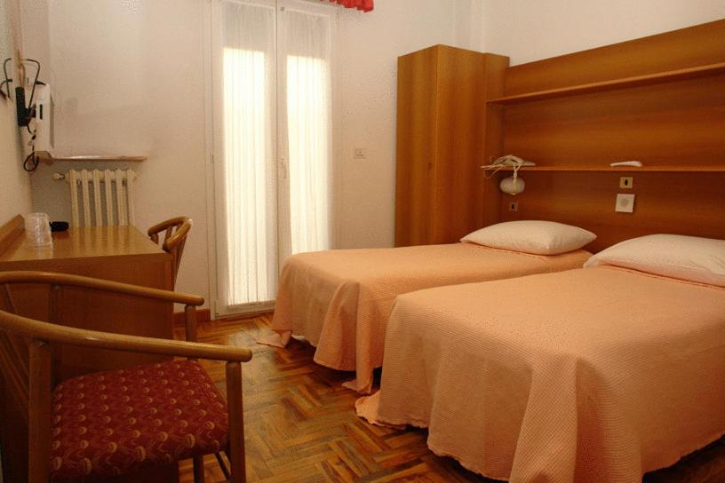 Postel nebo postele na pokoji v ubytování Hotel Torrismondi