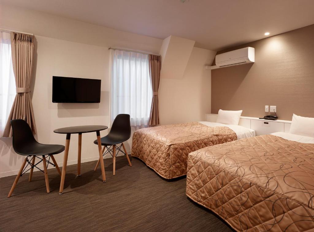 TV a/nebo společenská místnost v ubytování Hotel New Tohoku