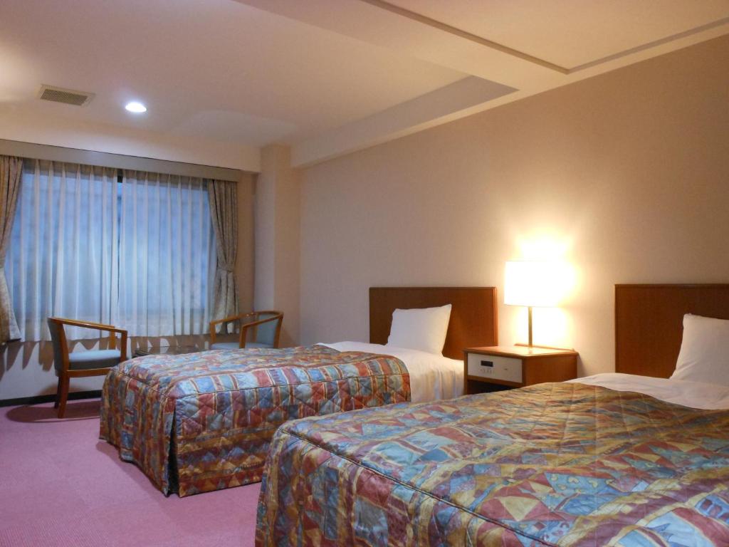 Postel nebo postele na pokoji v ubytování Hotel New Tohoku