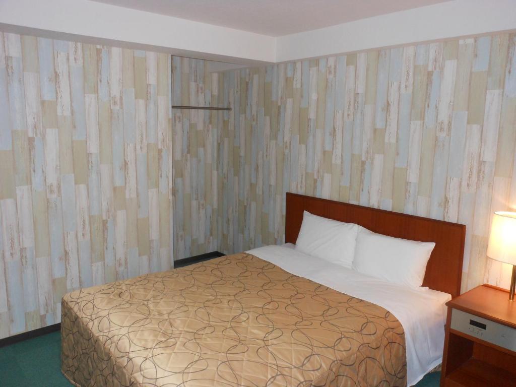 Postel nebo postele na pokoji v ubytování Hotel New Tohoku