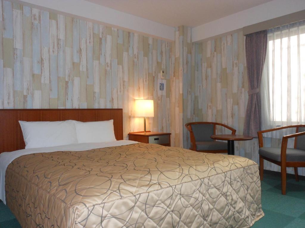 Postel nebo postele na pokoji v ubytování Hotel New Tohoku