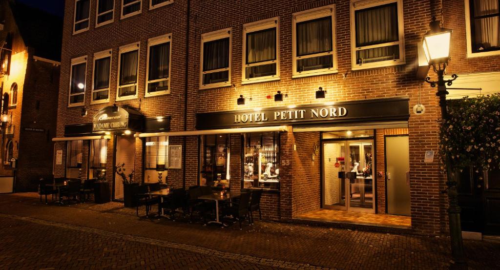 a building with a clock on the front of it at Hotel Petit Nord in Hoorn