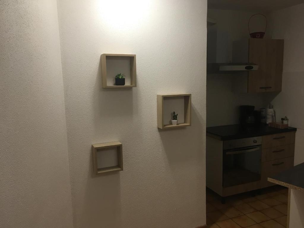 a kitchen with two small boxes on the wall at Le Château du Fleckenstein in Sélestat