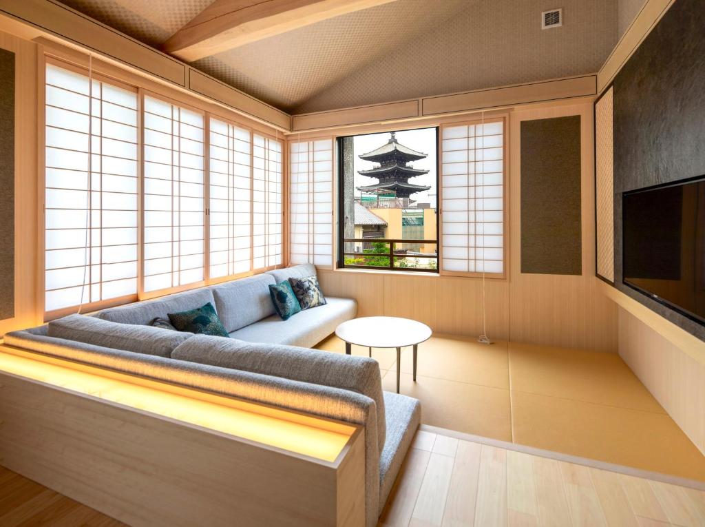 a living room with a couch and a tv at Campton Kiyomizu Vacation Rental in Kyoto