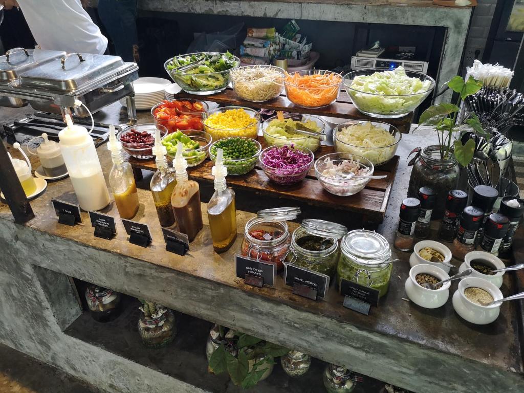 a buffet with many different types of food on a table at Wonderland Healing Center in Thongsala