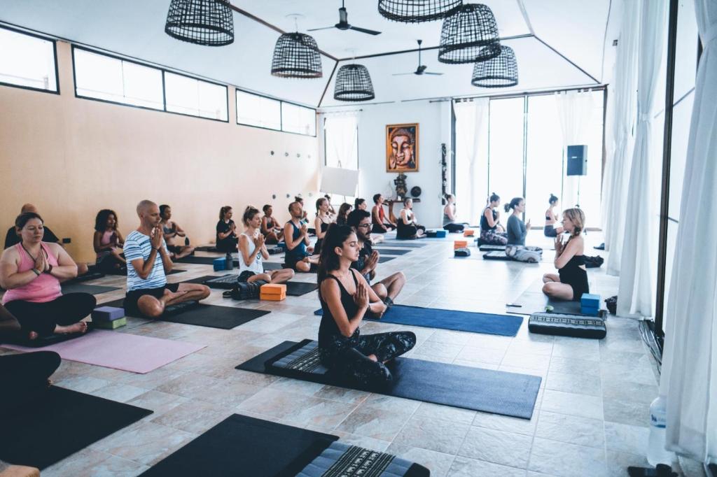 a group of people sitting in a yoga class at Wonderland Healing Center in Thongsala