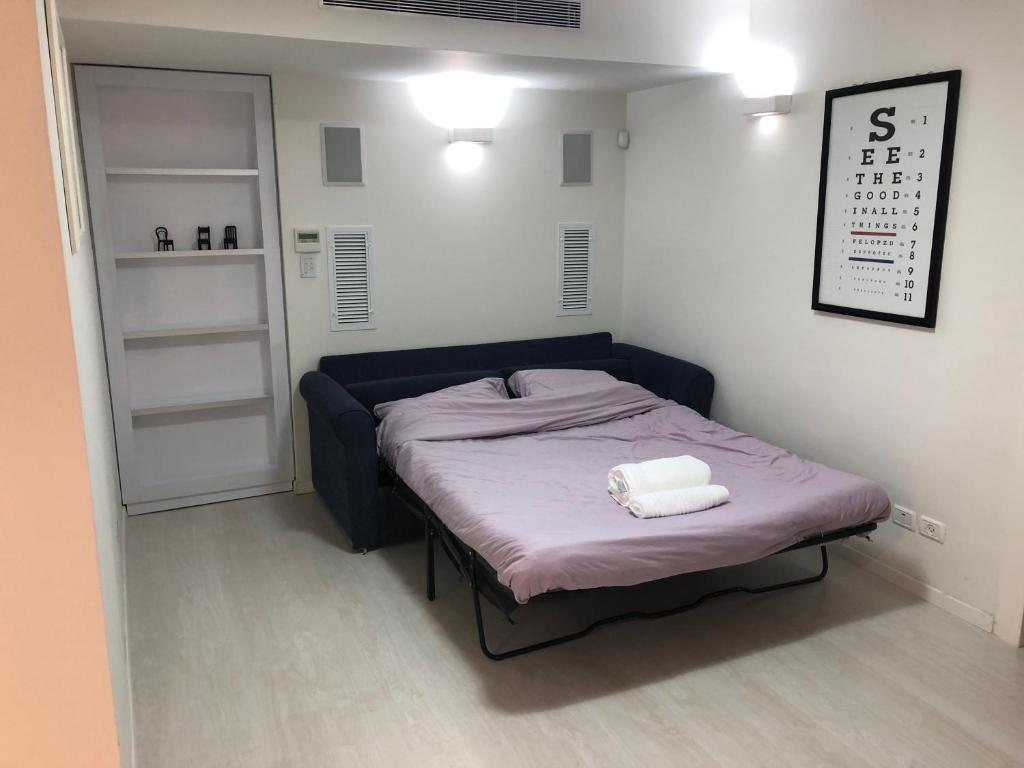 1 dormitorio pequeño con 1 cama con 2 toallas en Buchman apartment near center, en Modi‘in