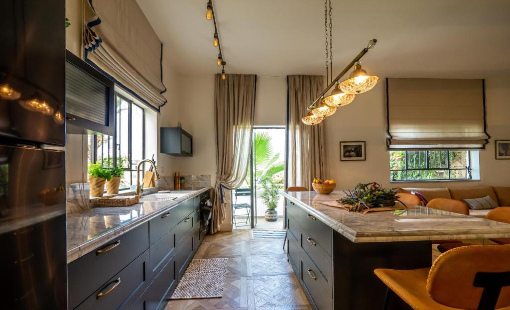 a kitchen with a large island in a room at VELLER Yehuda Halevi in Tel Aviv