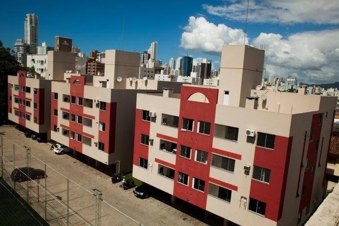 a red and white building with a city in the background at HOSTEL SERUSSI in Balneário Camboriú