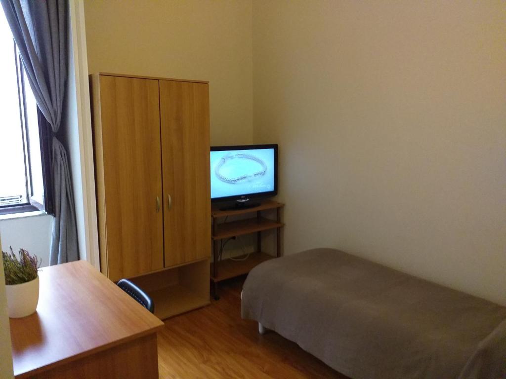 Uma televisão e/ou sistema de entretenimento em Relax in Centro