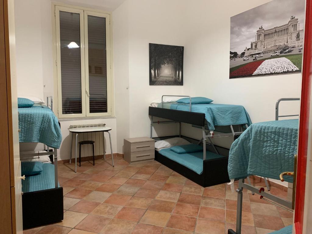 a room with two bunk beds and a window at Zidan Guest House in Rome