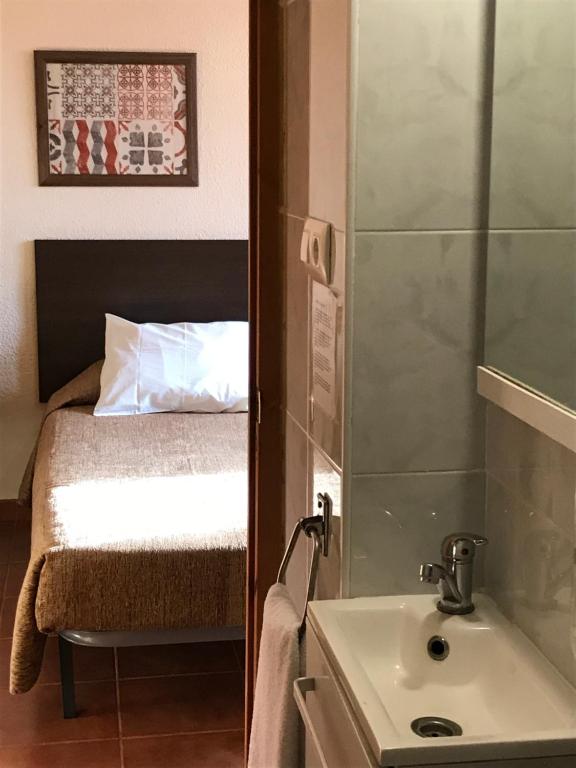 Postel nebo postele na pokoji v ubytování Hostal El Callejón