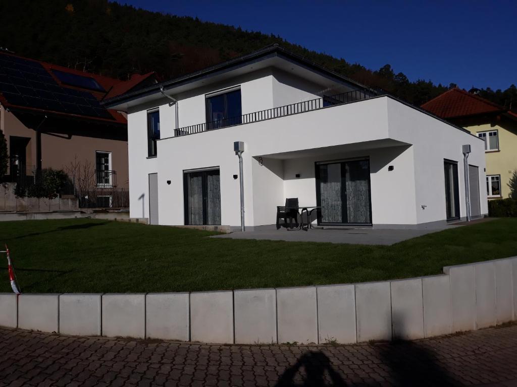 a white house with a lawn in front of it at Fewo Haus Edith in Lug
