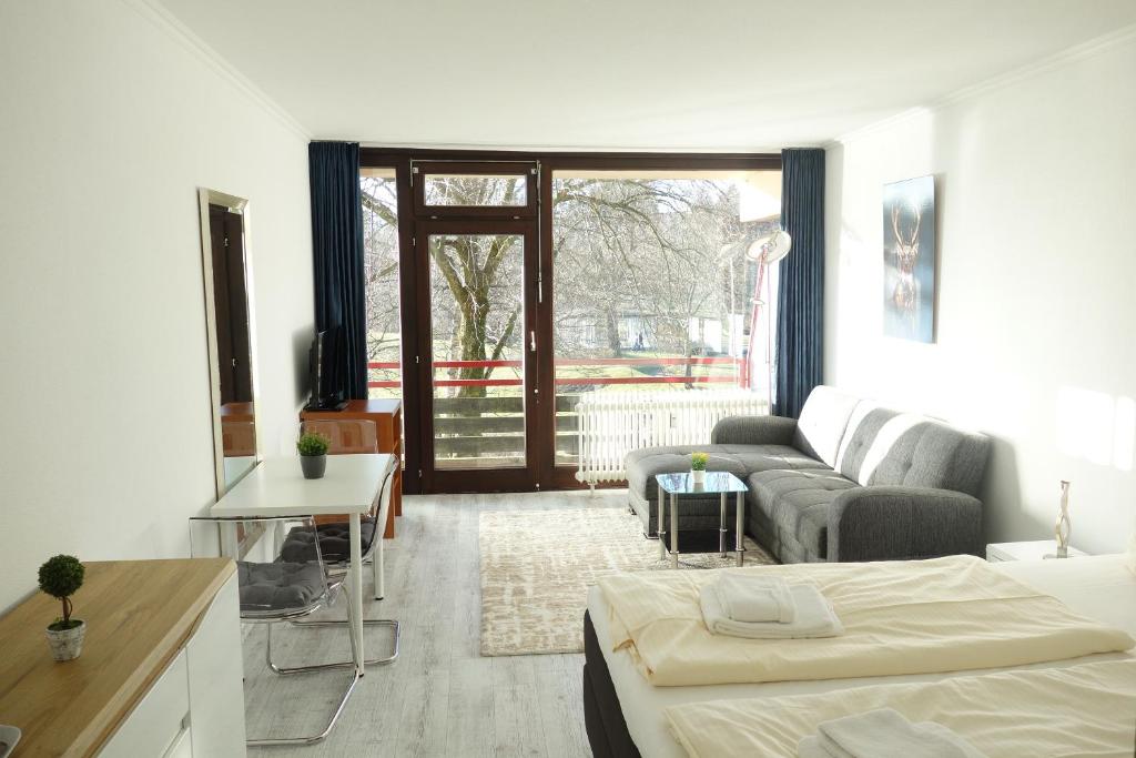a living room with a couch and a bed in it at Appartement Anne in Hahnenklee-Bockswiese