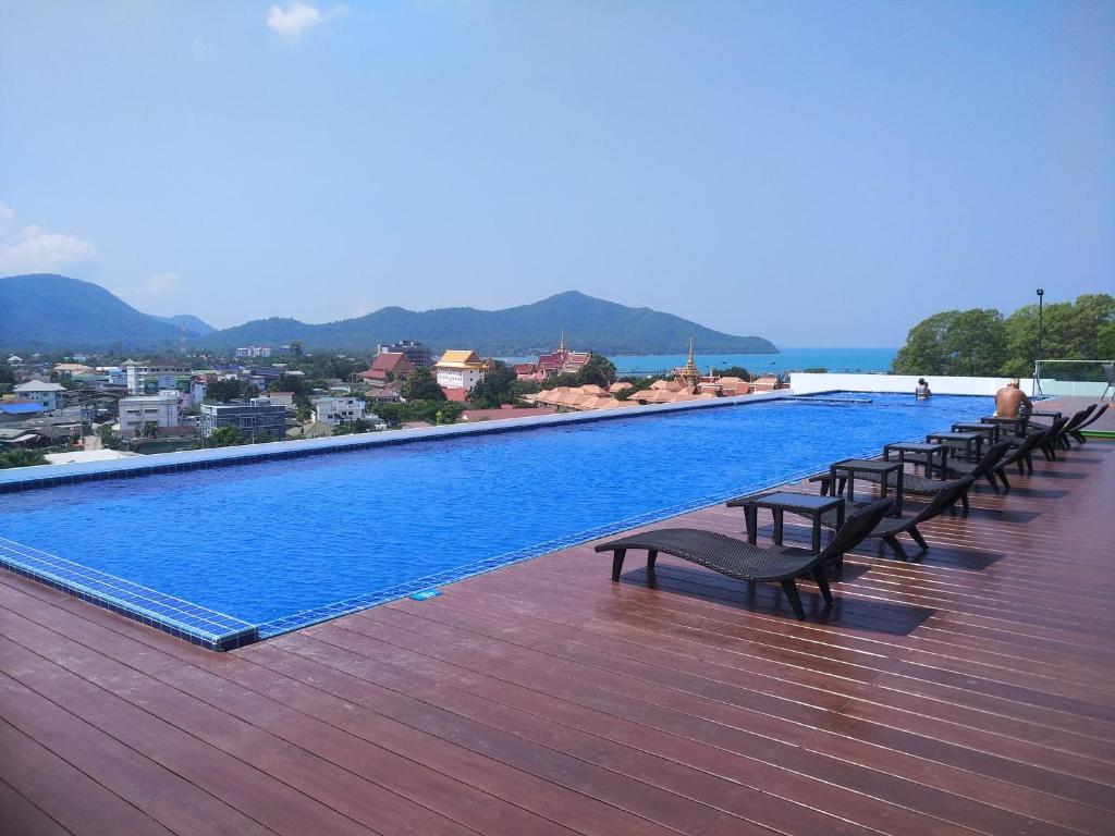 a row of benches sitting on top of a swimming pool at Sea Saran Condominium for Short-Term Stay in Bang Sare