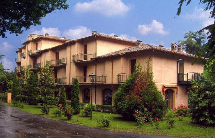 a large building with balconies on the side of it at Hotel La Meridiana in Brisighella