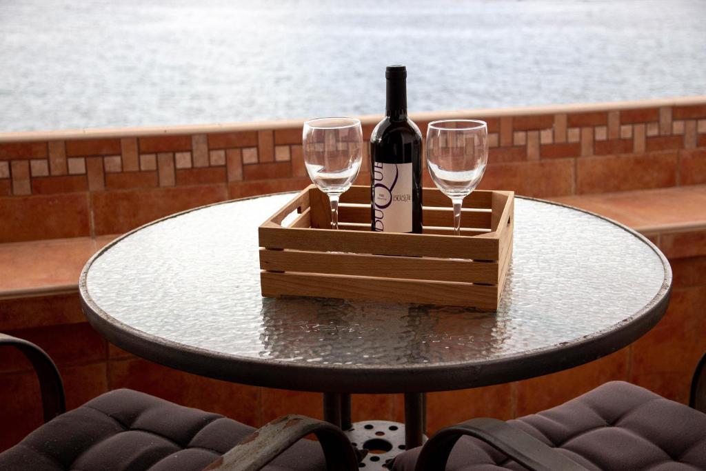 a table with a bottle of wine and two glasses at Looking the VIEWS - 214 in Costa Del Silencio