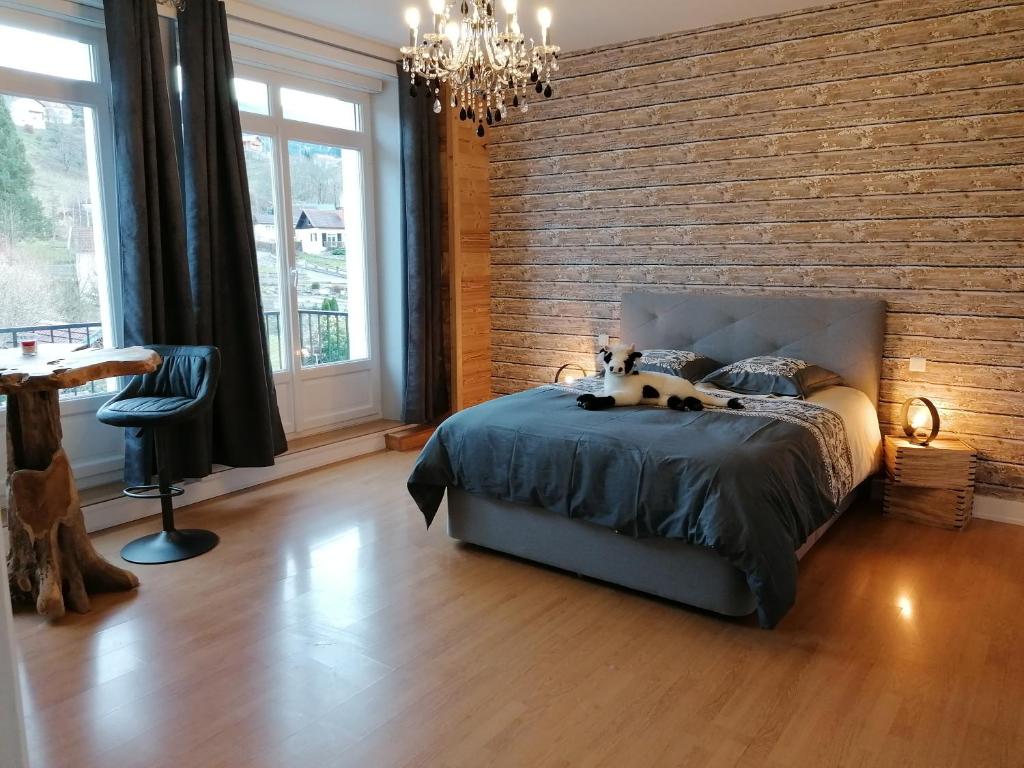 um quarto com uma cama e uma parede de tijolos em Chez MARLYSE-chambres et Table d'hôtes em Saint-Maurice-sur-Moselle