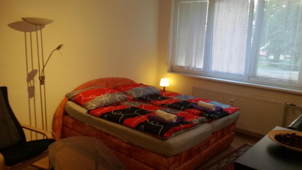 a bedroom with a bed in a room with a lamp at Flat for 2 people, WiFi in Ostrava