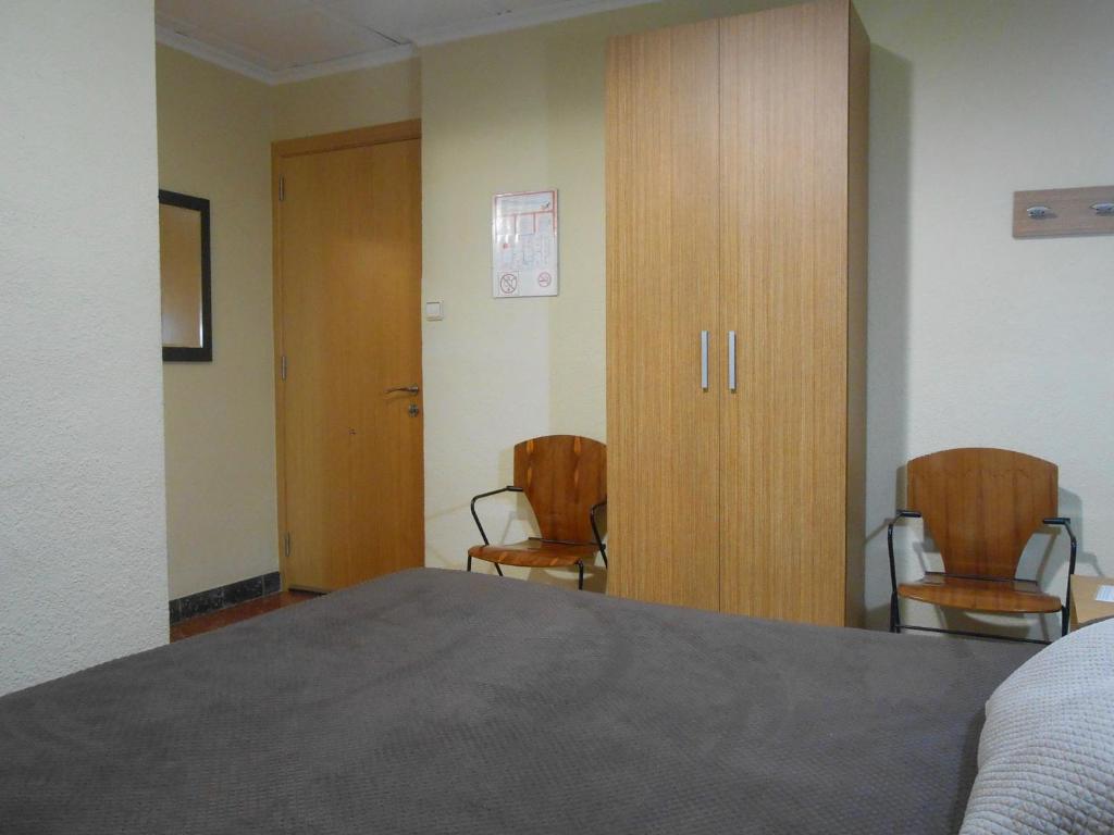 Postel nebo postele na pokoji v ubytování Hostal El Callejón