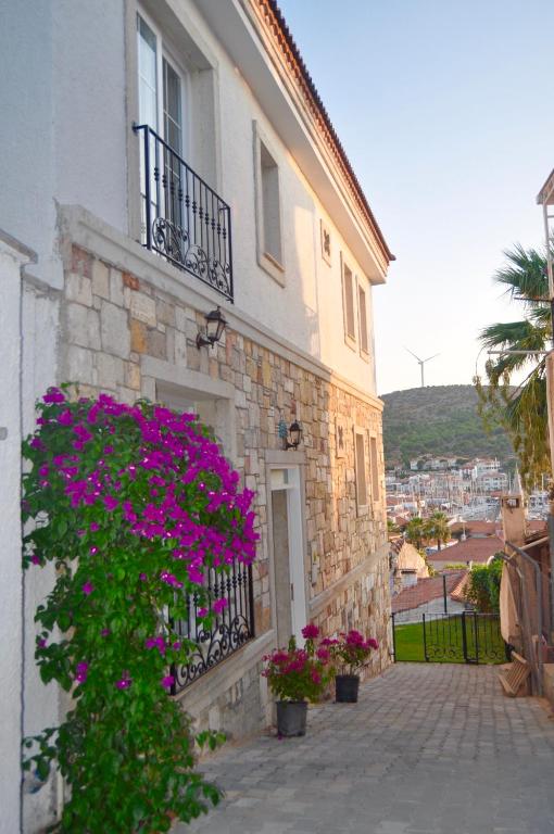 a building with purple flowers on the side of it at Villa Veria in Çeşme