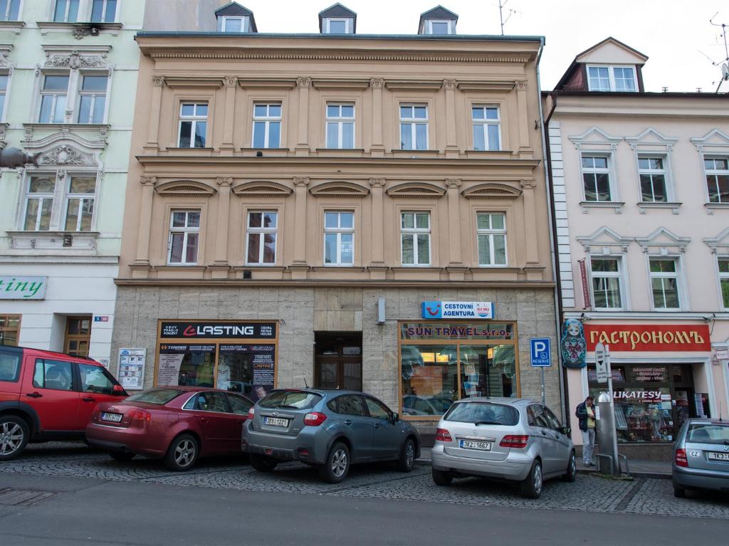 a group of cars parked in front of a building at Apartman "Alika" in Karlovy Vary